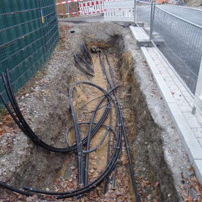 Bauarbeiten in der Planstraße A: zu sehen ein Kanal mit Verkabelung und Absperrung