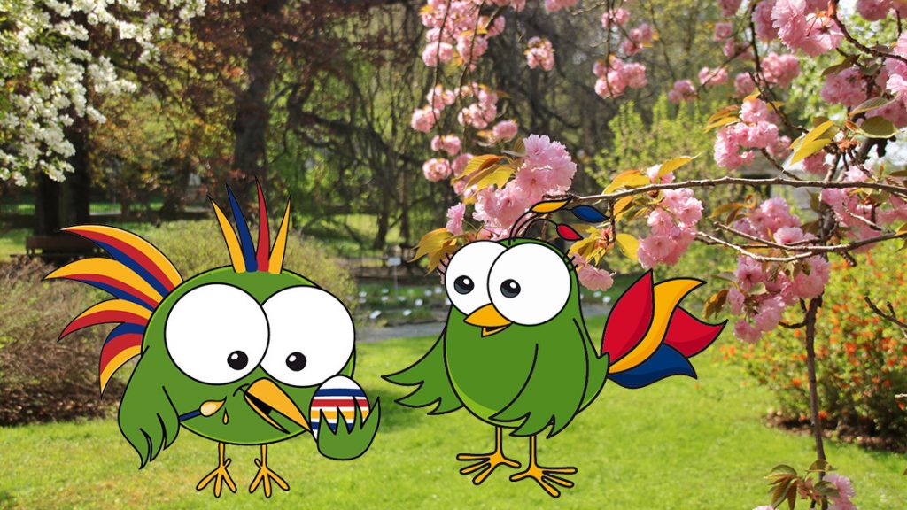 Foto mit Kirschblüten im Botanischen Garten Jena, darauf zwei Comicfiguren: Paradiesvögel beim Ostereier färben