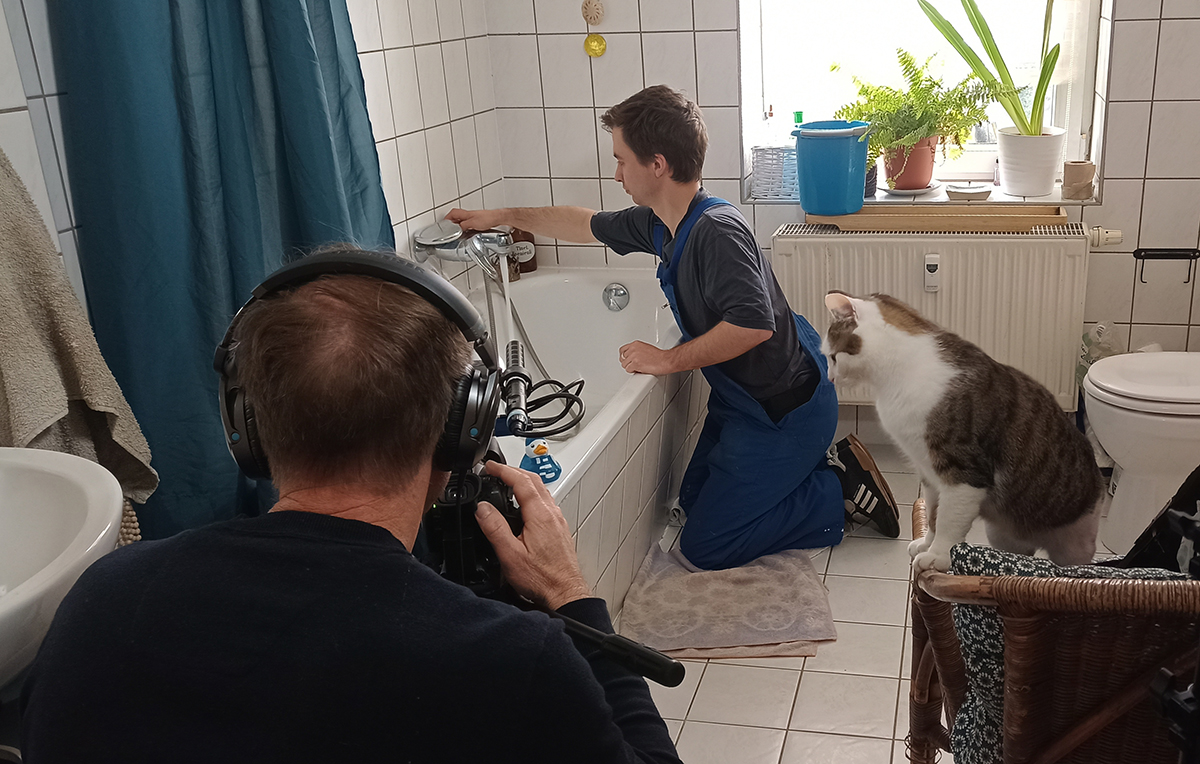 Dreharbeiten im Bad, Kater Findus von Max Pellny (im Hintergrund) gibt Uwe Germar Regieanweisungen