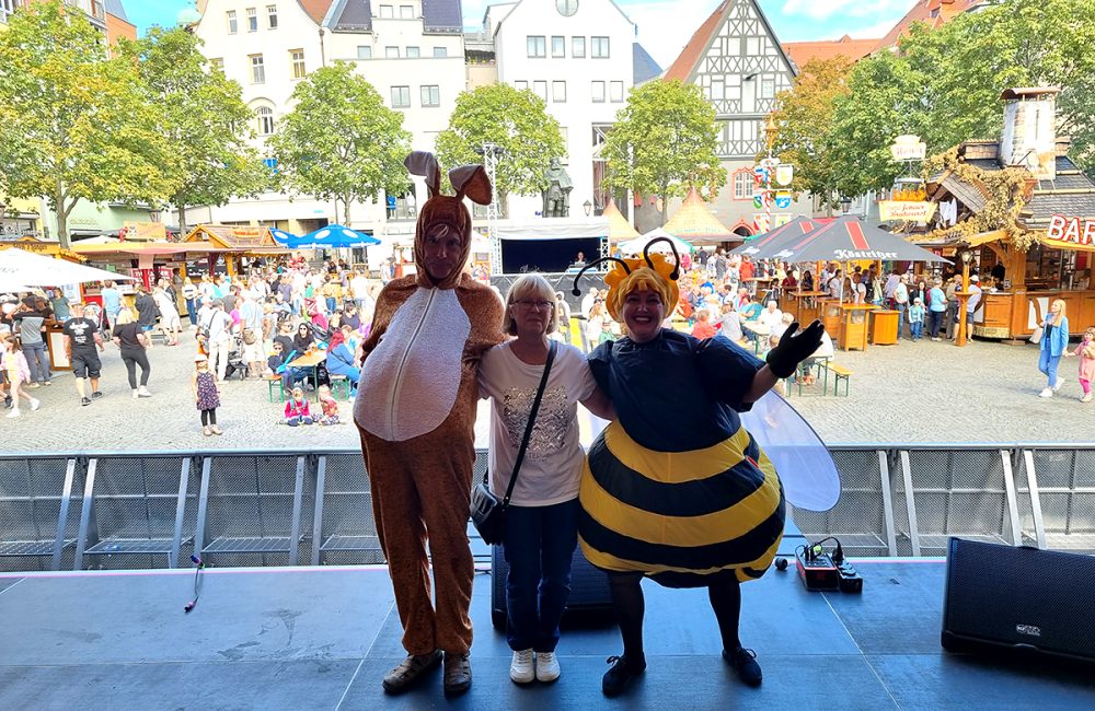 Karin Wittig zusammen mit Künstlern auf der Bühne des Jenaer Frühlingsmarktes